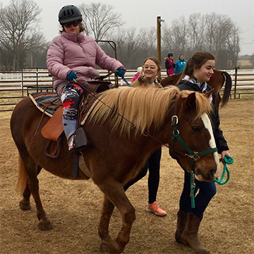 Child on a horse at OSU Turning Point Ranch