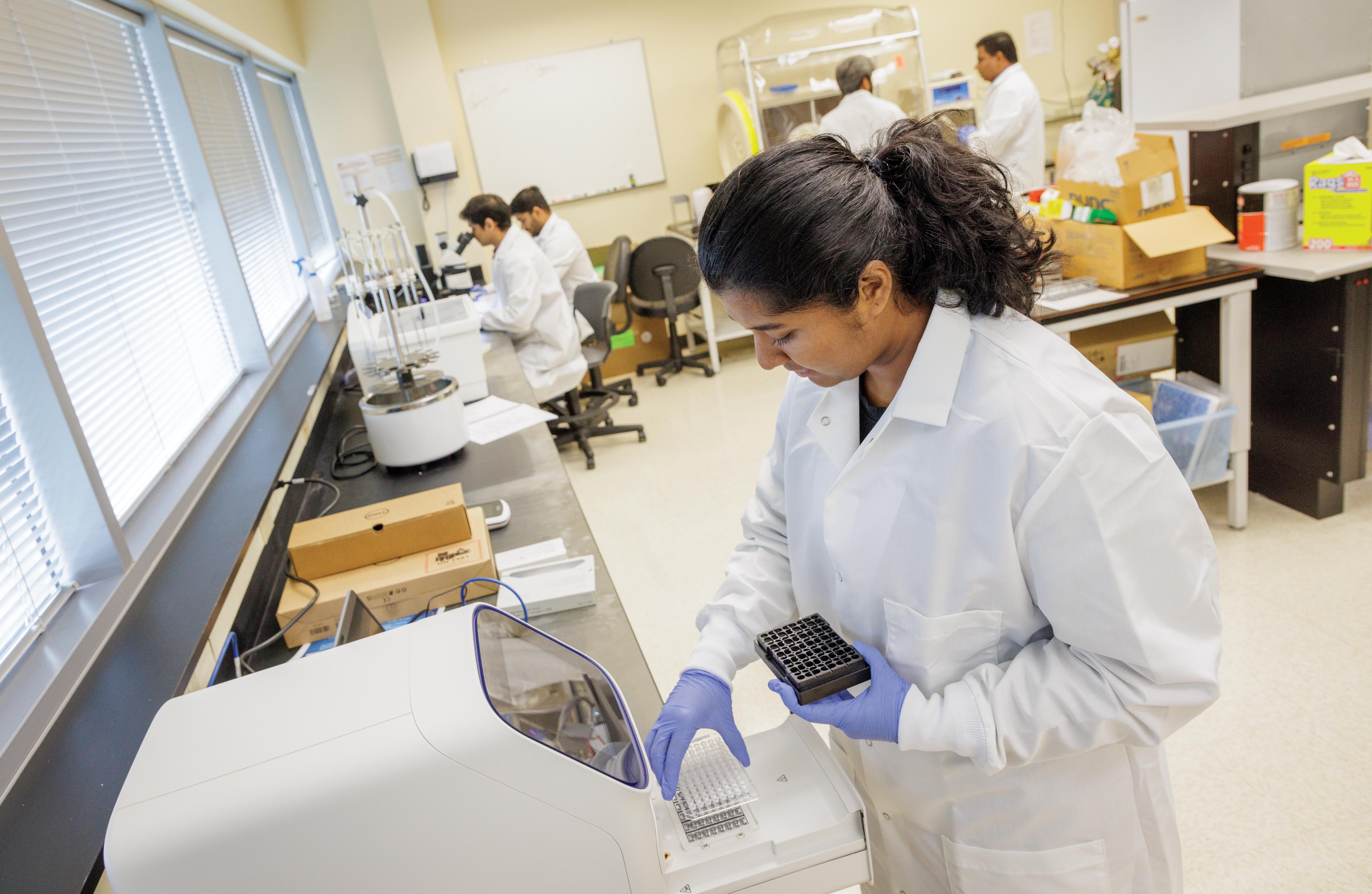 Binta Varghese, right, works in the lab at Venture One.