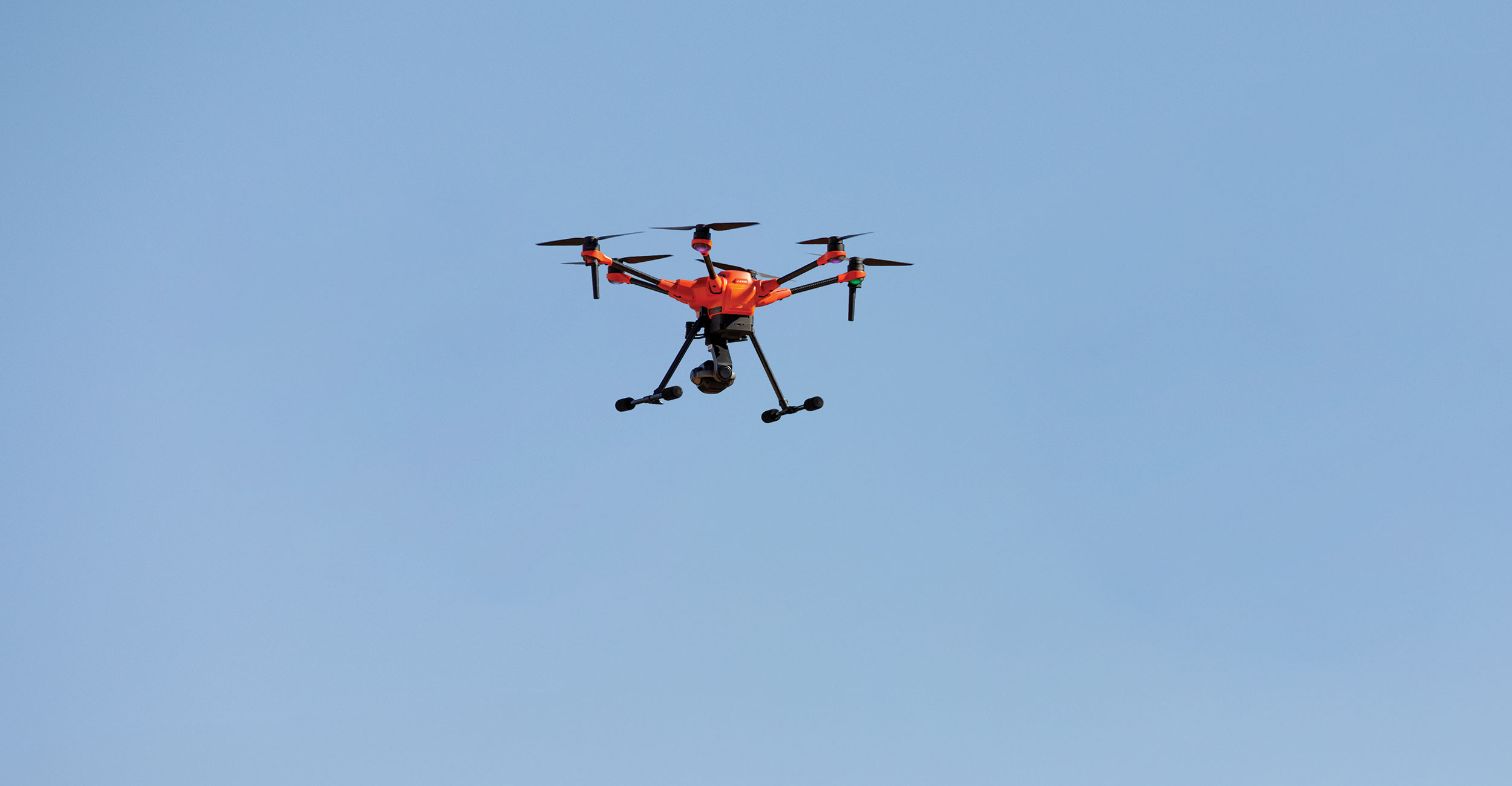 a 4 prop drone flying in the air