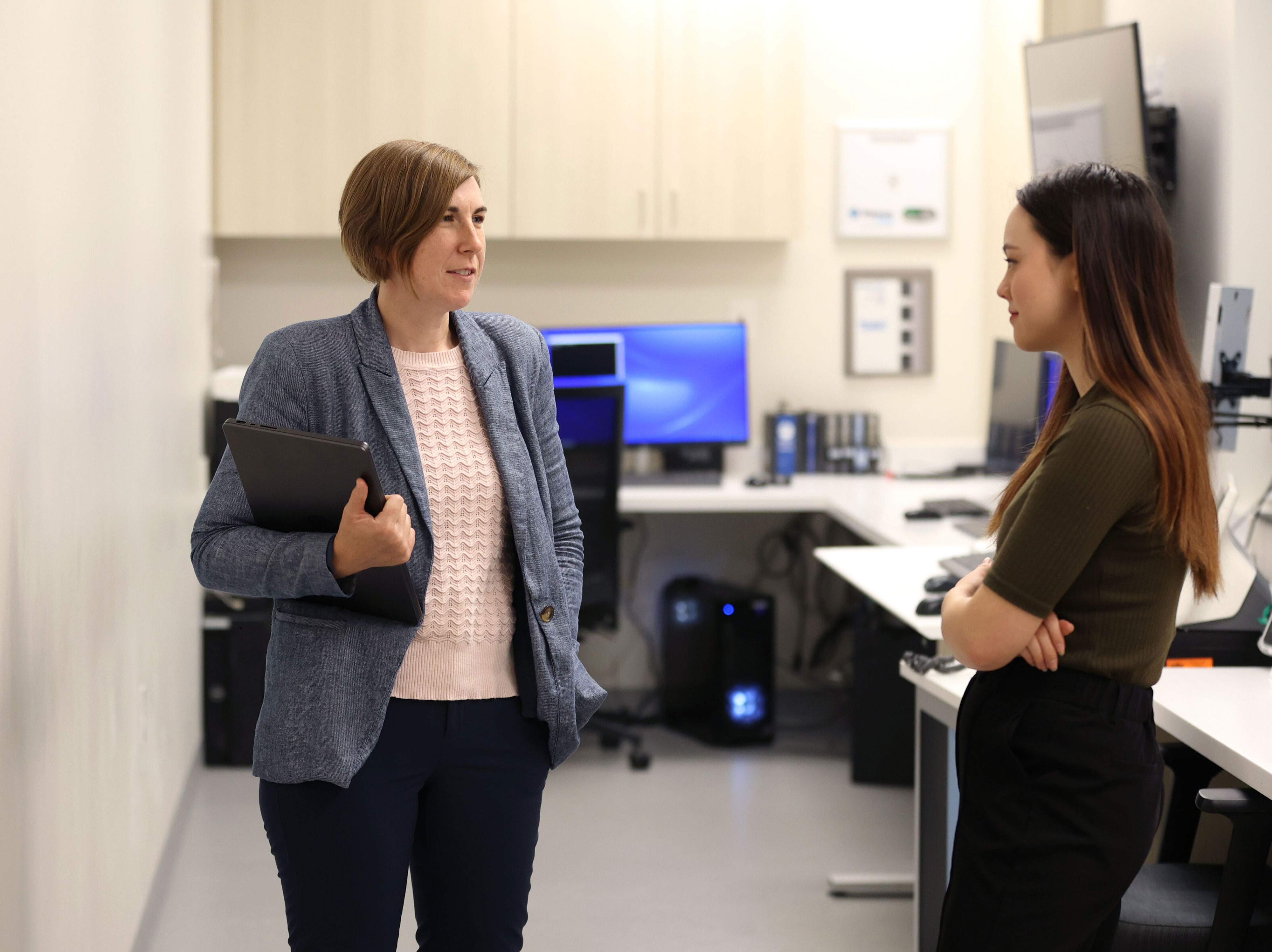 Kerr, left, talks with research assistant April Anderson who is assisting with a hyperscanning research project at the Hardesty Center for Clinical Research and Neuroscience.