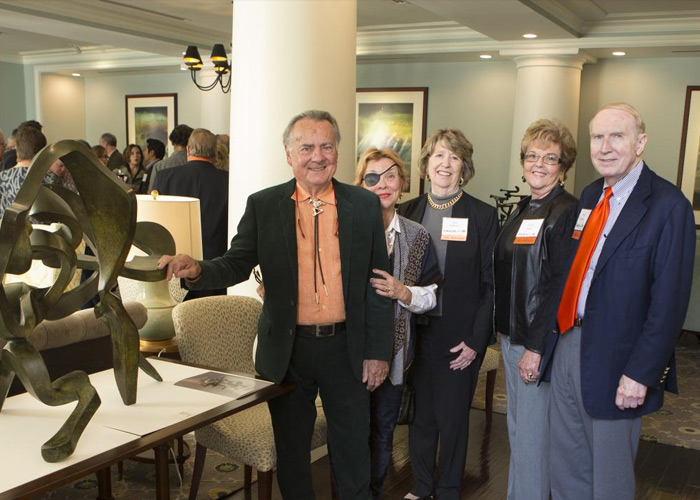 Artist Bill Barrett, left, visited with guests at a reception in the Atherton