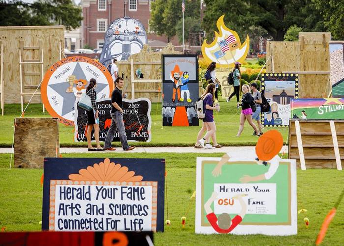 Homecoming theme signs on OSU's library lawn.