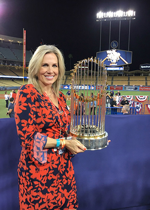 Brenda Schiro holds up World Series trophy