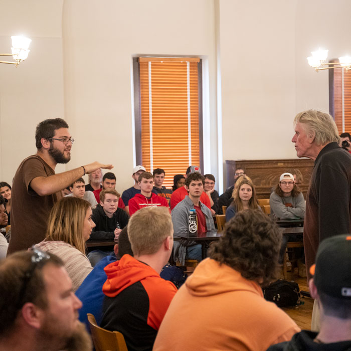 Busey speaks with student