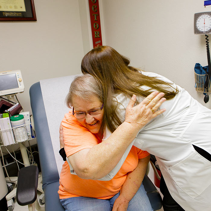 patient gives hug to doctor