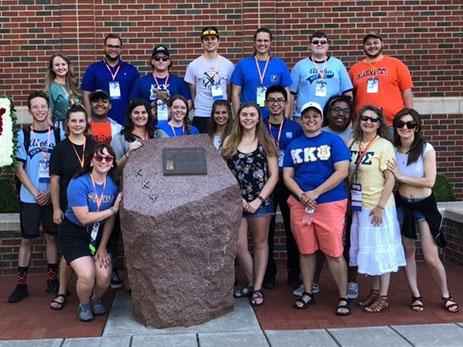 Alpha Chapter members pose with the Kappa Kappa Psi shrine on the OSU campus during the centennial celebration.