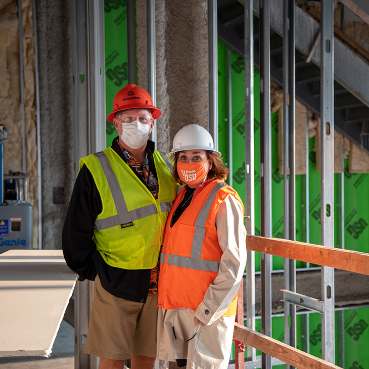 Michael and Anne Greenwood stand in the soon-to-be-complete student lounge during their Dusty Boots tour of the new Greenwood School of Music building