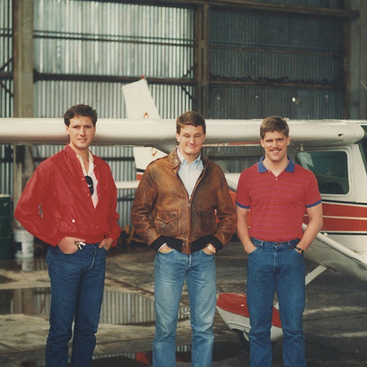 Philip Martin, Kevin Fergerson and Mark Schulz pose by an OSU airplane in the early 1980s.