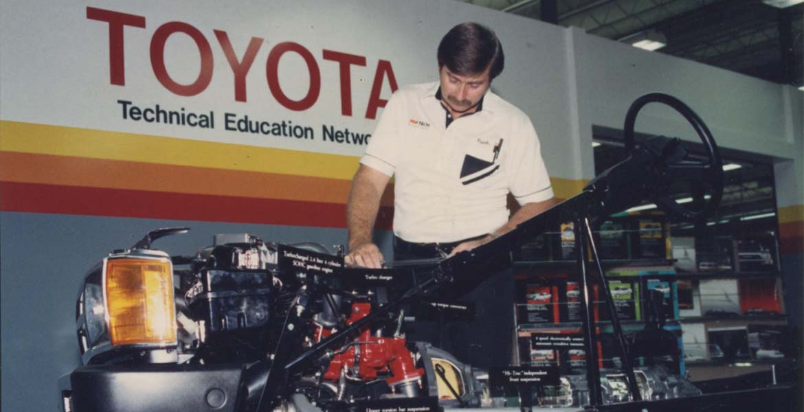 a photo from the 1980s of an OSUIT student working on a Toyota engine