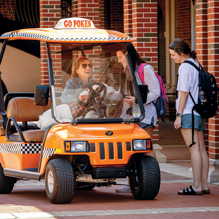 Ann Hargis talking with students on campus.