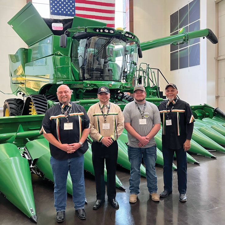 Chad Johnson (left) and his father, Gary Johnson (right), on a “gold key tour” inside John Deere’s Waterloo, Iowa, assembly plant with Chairman Tim Rhodd (second from left) of the Iowa Tribe of Kansas and Nebraska and member Kyle Rhodd (third from left).