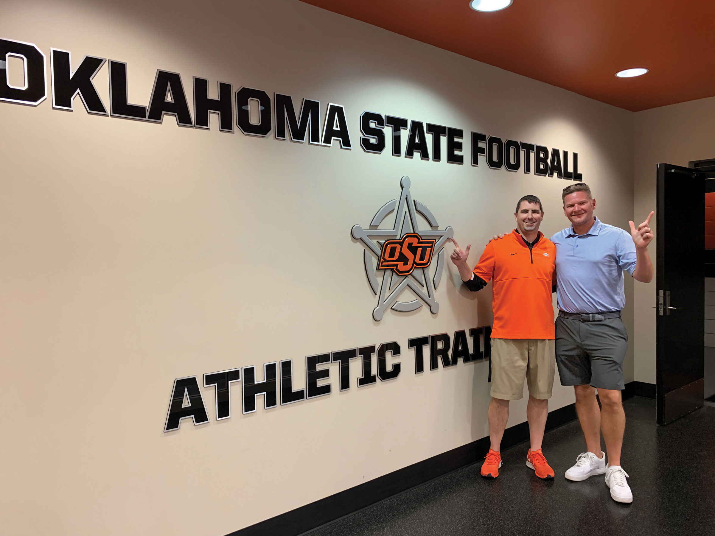 Denny Kellington and Scott Parker, OSU head football athletic trainer, met up in 2022 as Kellington returned to campus to see how the athletic facilities had changed since his time as a student.