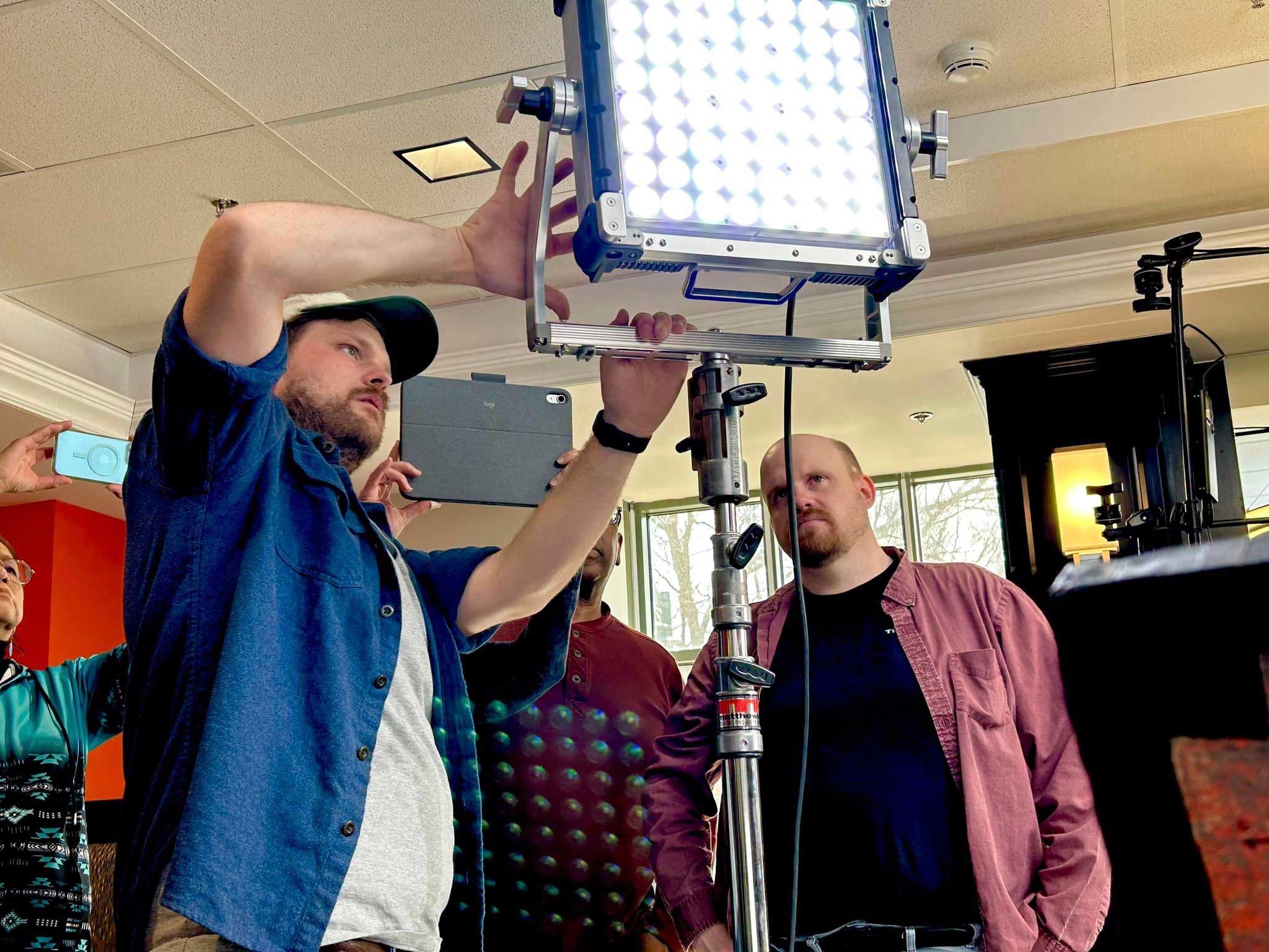 Professional lighting technician and instructor Jake Basnett demonstrates the proper usage of a light during “The Art of Cinematic Lighting” workshop.