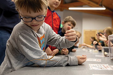 Children and youth, including 7-year-old Elias Mattox-Wilburn of Stillwater, explore insects and entomology during an OSU Extension Insect Adventure open house at The Botanic Garden at OSU.