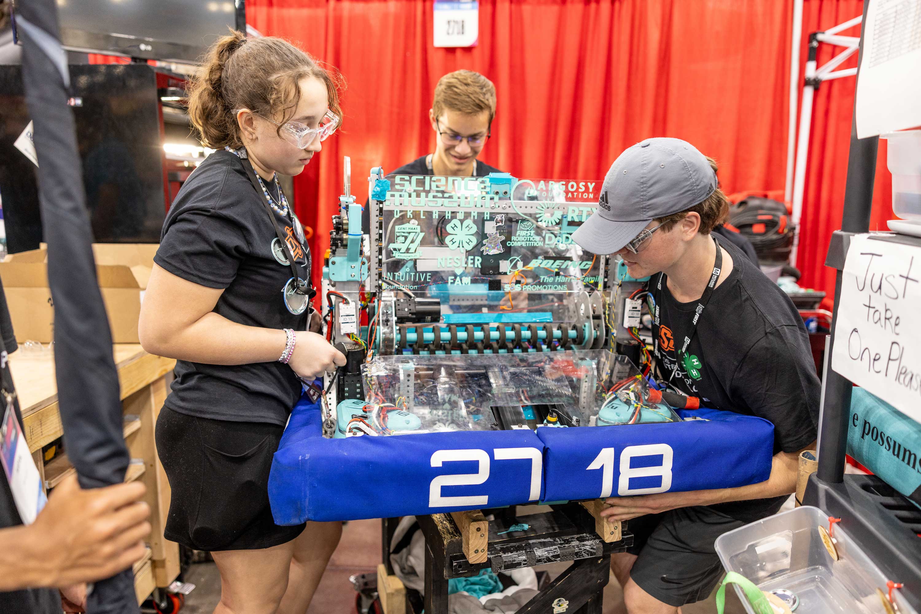 Members of Team OKC work on their robot in Houston at the FIRST Robotics World Championships in April.