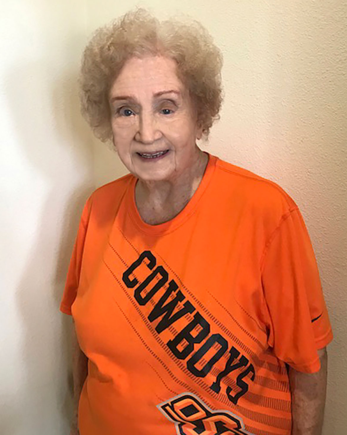 Ruth Spivey, OSU's first female graduate in her field posing in an OSU shirt.