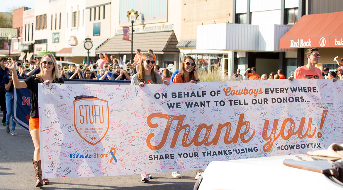 The Student Foundation carrying a Stillwater Strong banner during a parade.