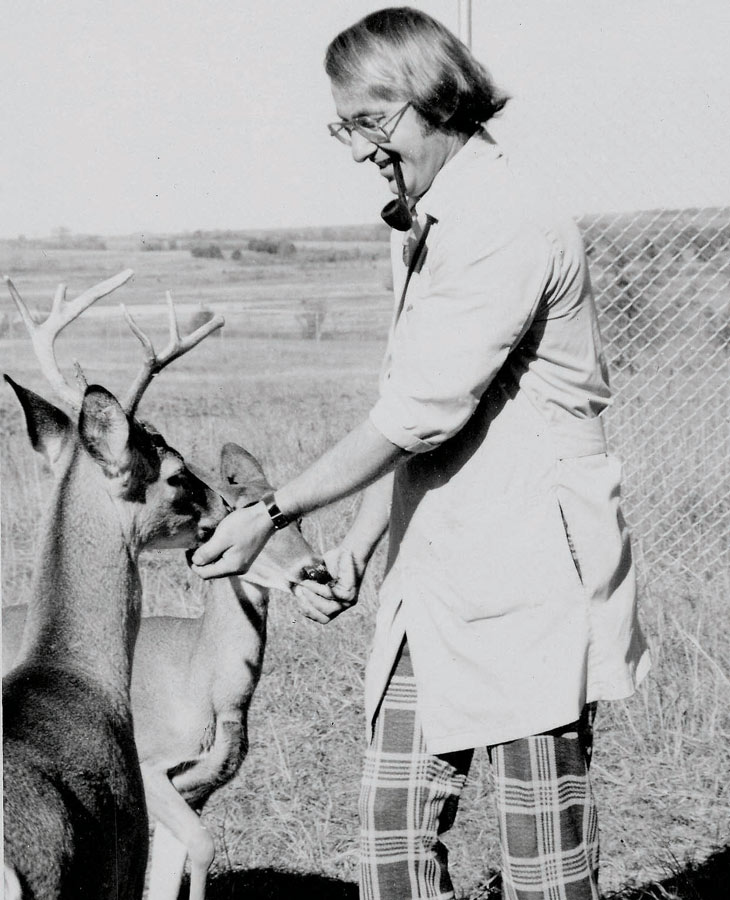 a female vet student feeds a deer