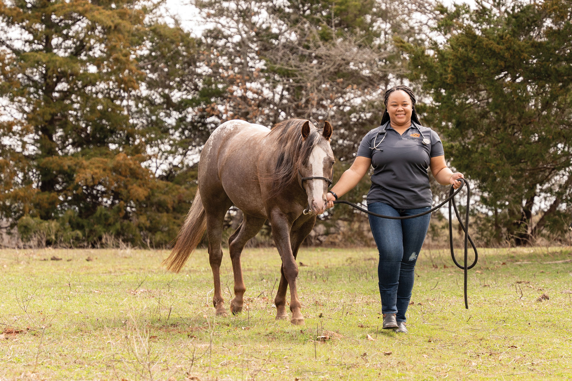a female vet student walks a horse