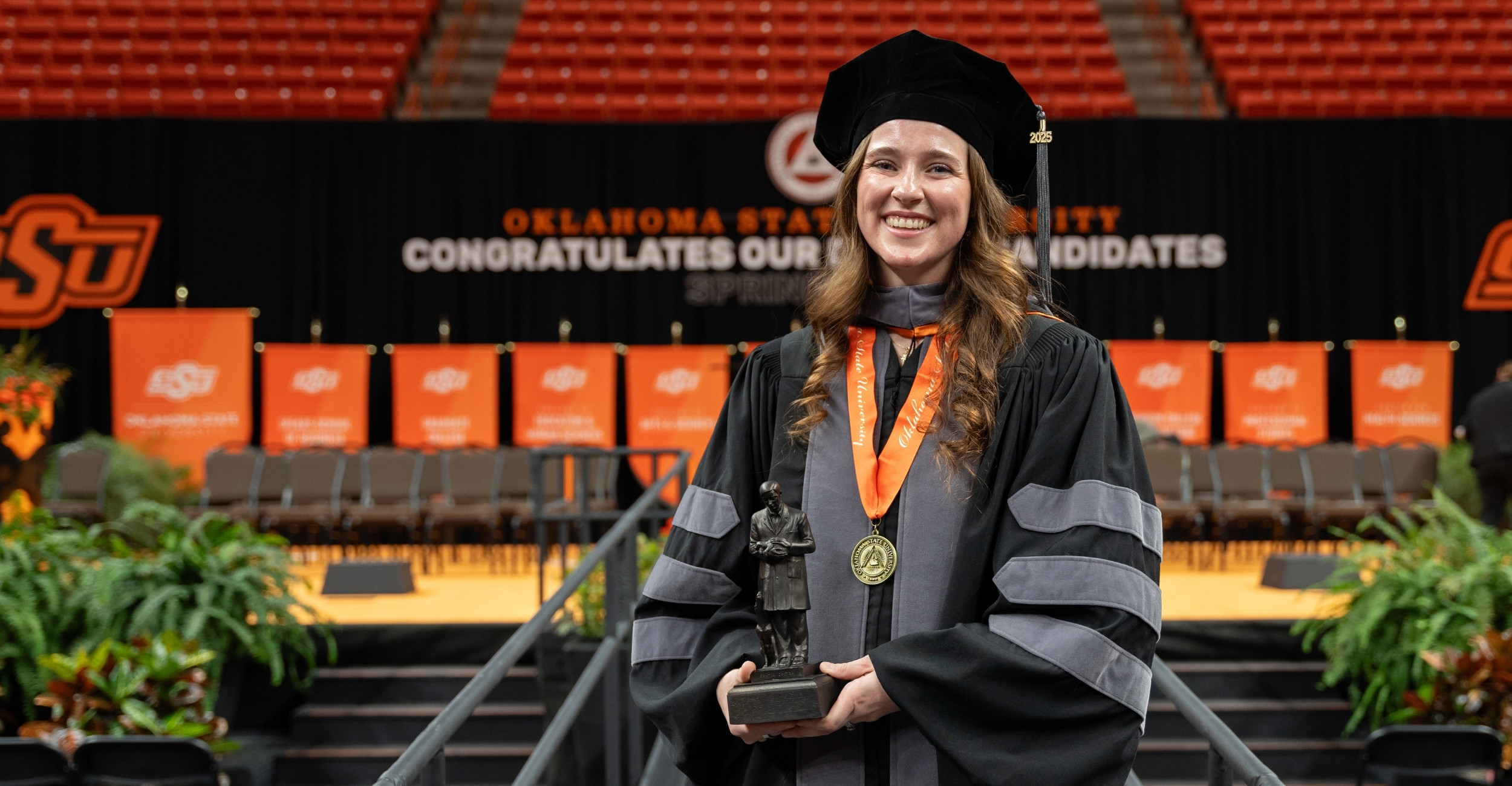 Jacqueline Casto at the 2025 commencement ceremony posed with her award.