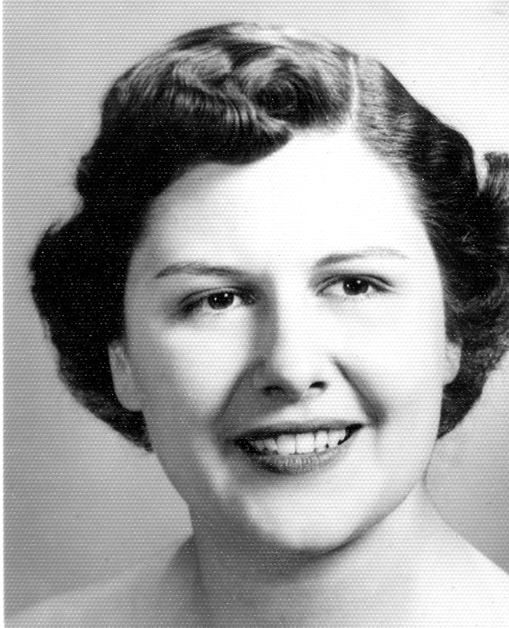 Person with short, wavy hair in a black-and-white portrait.