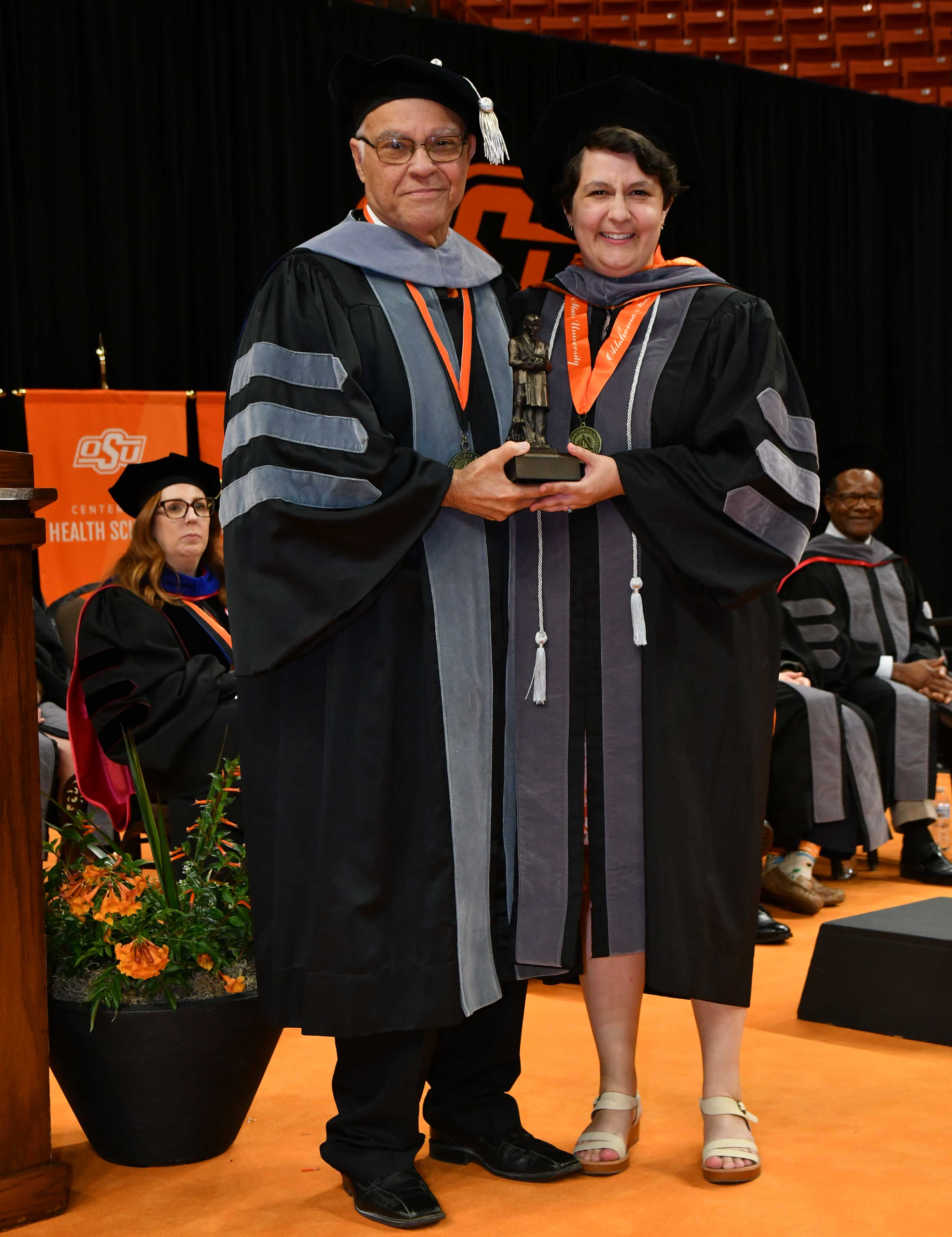 Dean Carlos Risco presents the Gentle Doctor award to Dr. Lindsay King at commencement.