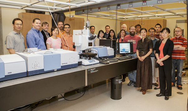 Researchers and students at OSU gather around the newly installed advanced infrared (FTIR) system that offers multiple research capabilities. Those pictured include project leader Dr. Aihua Xie (sixth from right), co-leaders Dr. Wouter Hoff (eighth from right) and Dr. Junpeng Deng (first from left). Department heads are Dr. John Mintmire, physics (third from left) and Dr. Frank Blum, chemistry (fifth from left).