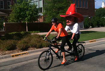 Pistol Pete and Suzy Harrington ride a tandem bike