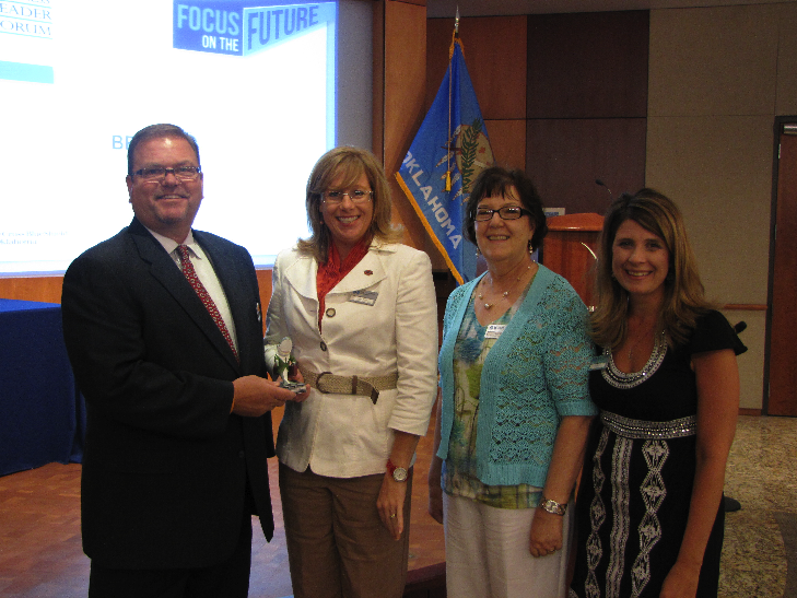 (l-r) Linza Jones with BCBS presents the Wellness Shark award to Jamie Payne and Anne Matoy from OSU, also pictured is Kerri Cook with BCBS.