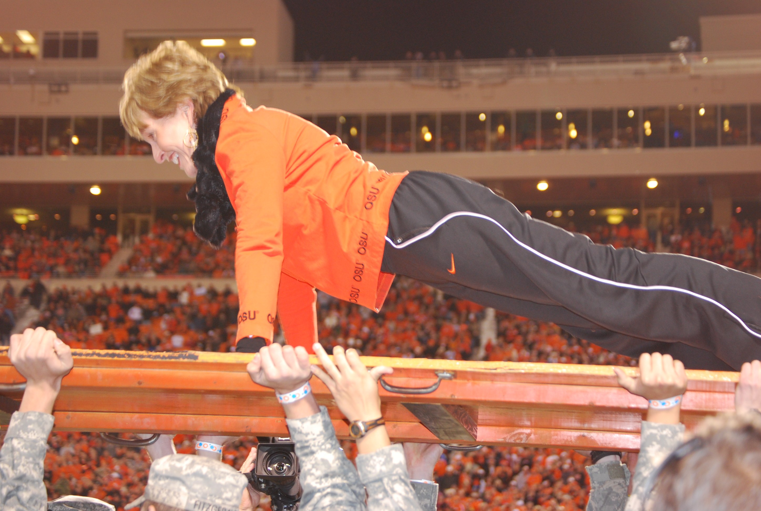 To celebrate the end of the Cowboys on the Move Competition, First Cowgirl Ann Hargis completed the first set of push ups on the ROTC push up board during the bedlam game.
