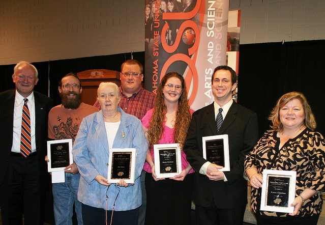 Photo from left: Regents Professor Peter M.A. Sherwood, dean of the College of Arts and Sciences with Wouter Hoff representing the microbiology and molecular genetics department, and award winners Pat Mann, Andrew Fullerton, Moria Harmon, Douglas Droste and Karen Christian.