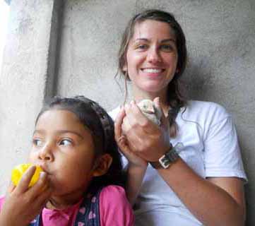 Caitlin Cleary is pictured with a child from the family she stayed with during a visit to Honduras. She is holding a chick from the family’s chicken coop.