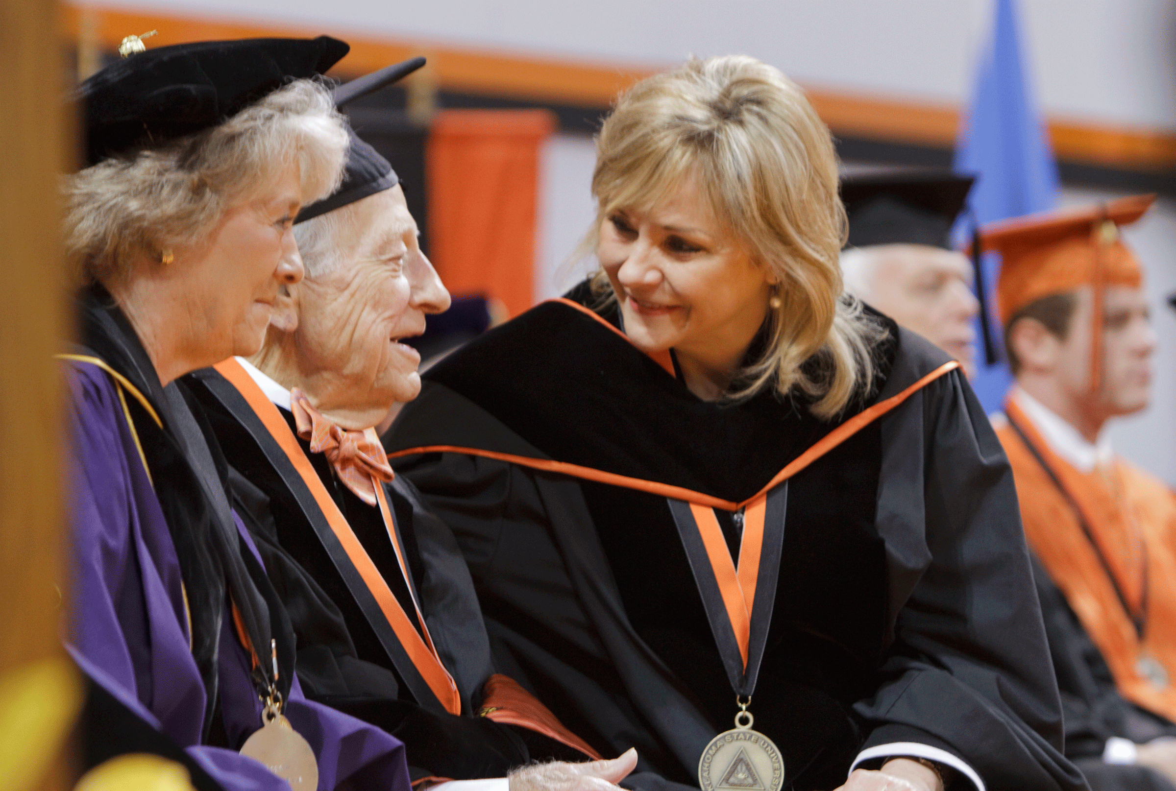 Oklahoma State University Commencement speaker, Oklahoma Governor Mary Fallin, speaks with Hubert Gragg who received his honorary doctorates degree during Saturday’s ceremonies.