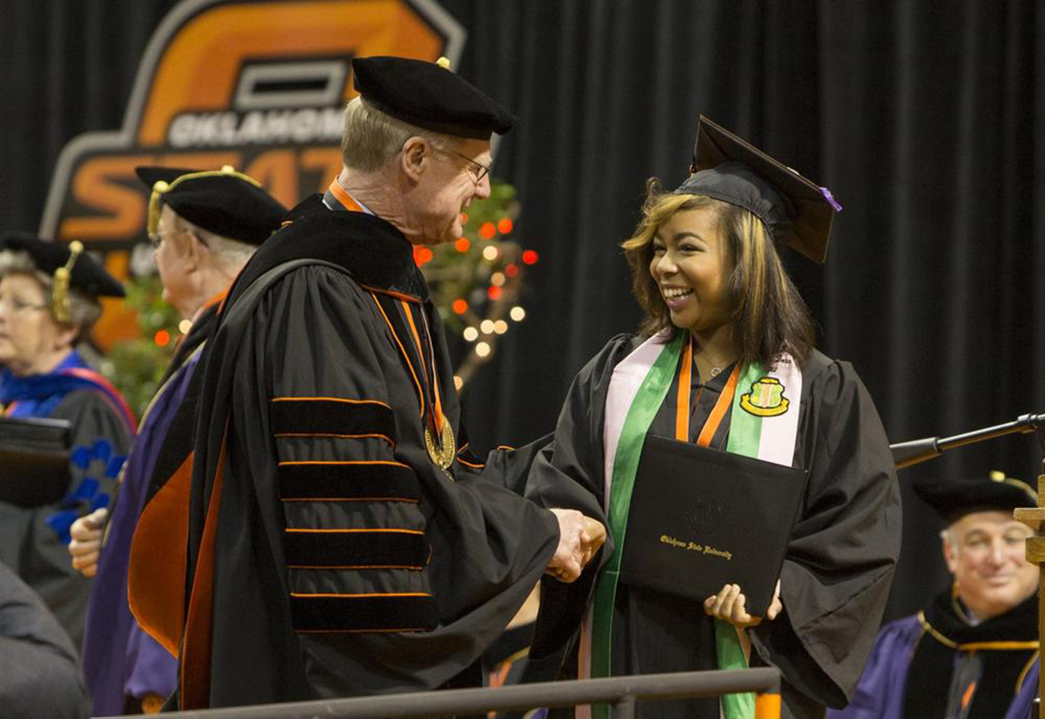 Oklahoma State University President Burns Hargis congratulates a graduate during OSU’s undergraduate commencement ceremonies Saturday at Gallagher-Iba Arena in Stillwater. More than 1,700 graduates were recognized during Graduate College and undergraduate ceremonies Friday and Saturday.