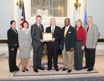 Wravenna Bloomberg, CEPD program coordinator (left); Julie Weathers, CEPD director; Larry Crosby, OSU Spears School dean; Gov. Brad Henry, Governor of Oklahoma; Oscar Jackson, Oklahoma OPM administrator and cabinet secretary of Human Resources and Administration; Lisa Fortier, Oklahoma OPM director of Human Resource Development Services; Hank Batty, Oklahoma OPM deputy administrator for programs.