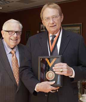 James G. Hromas (right) received a Bennett Fellow award from the School of International Studies at Oklahoma State University. Hromas was presented the award by B. Curtis Hamm (left), a previous Bennett Fellow recipient. He also received a Boger Professor medallion from Gary Clark, OSU vice president and general counsel (not pictured).