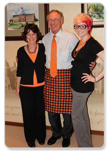 Diane Morton, DHM clinical instructor and Kelsie Mitchell, DHM senior from Oologah, Okla. present the official OSU tartan kilt to OSU President Burns Hargis.