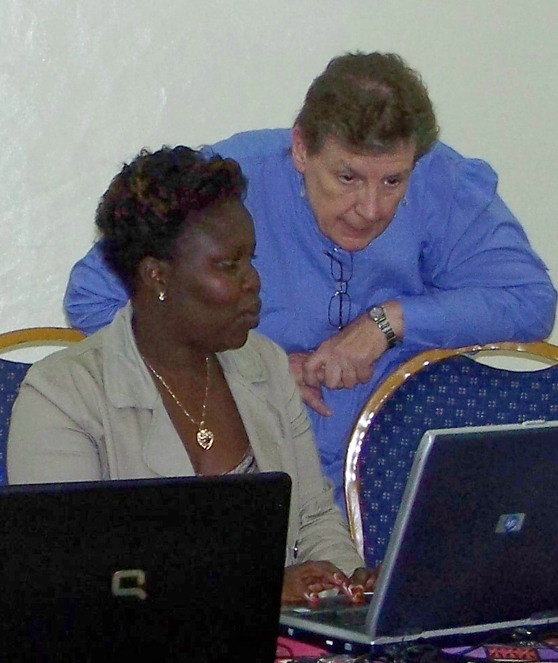 Spears School of Business professor Margaret White assists a faculty/doctoral candidate at the Moi University of Eldoret, Kenya. White and fellow faculty member Gary Frankwick spent two weeks in Kenya last fall, where they instructed more than 15 faculty/doctoral candidates about research ethics and writing scholarly journal articles and dissertations.