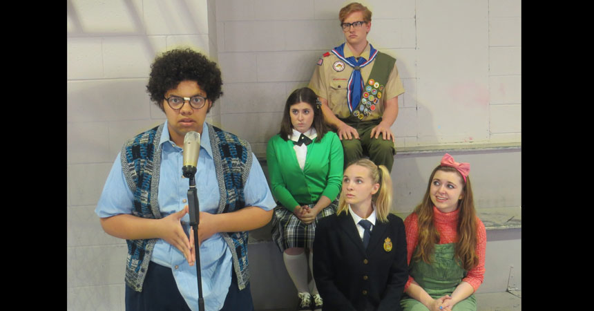 Students posing during a rehearsal for the production